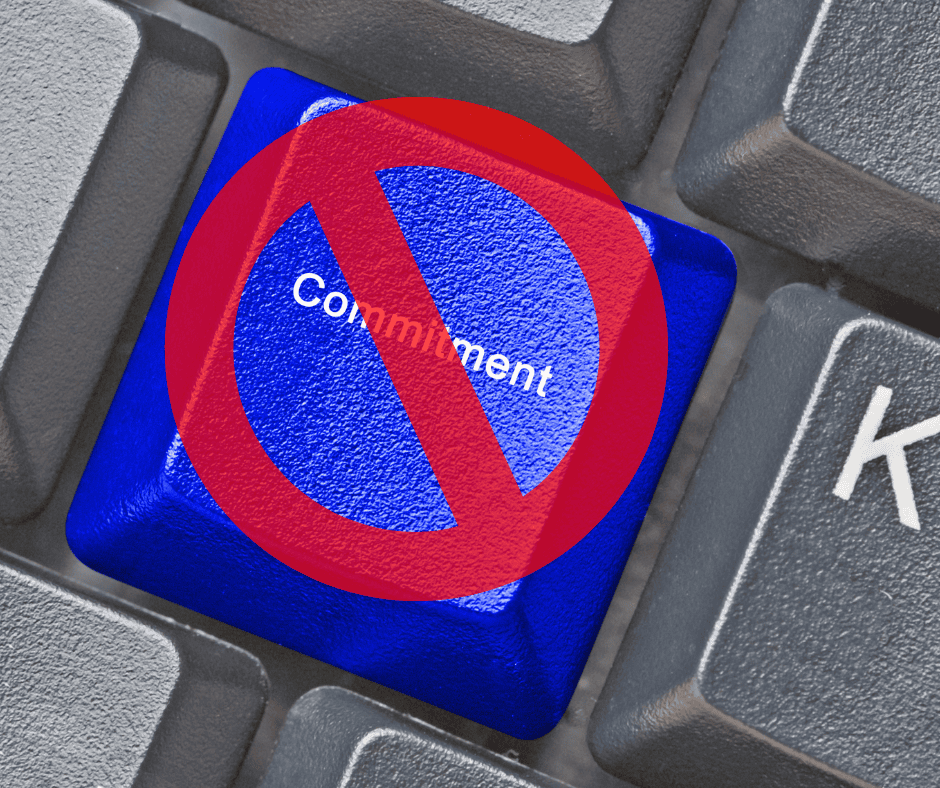 A computer keyboard key labeled “Commitment” overlaid with a red prohibition symbol, suggesting restraint or reconsideration.