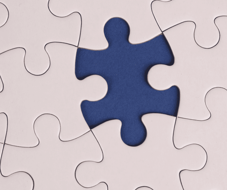 A blue puzzle piece missing from a white jigsaw puzzle, symbolizing the overlooked space between amateur and professional.