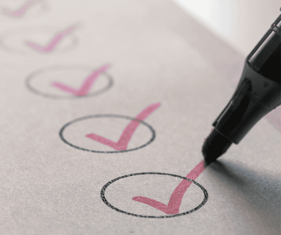 A close-up of a pen marking a checkmark on a to-do list, symbolizing completion and the act of choosing what gets done.