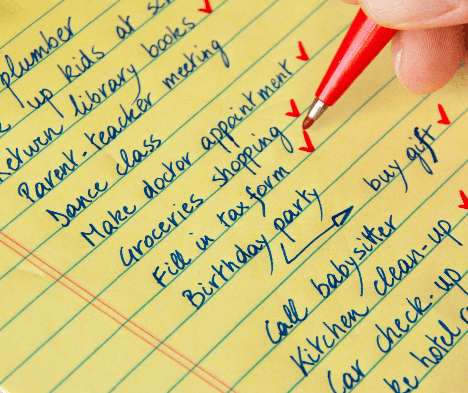 Handwritten to-do list on yellow paper with specific action-based tasks being checked off in red pen.