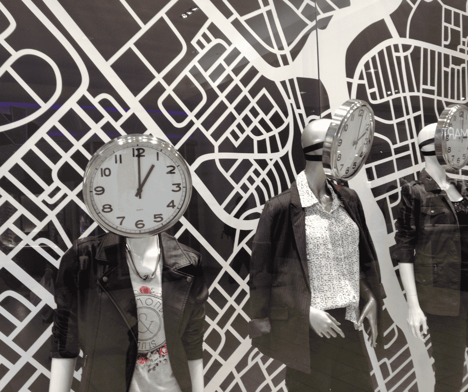 Mannequins with analog clock faces for heads stand before a layered street-map backdrop, suggesting how time replaces identity and reveals meaning gradually.