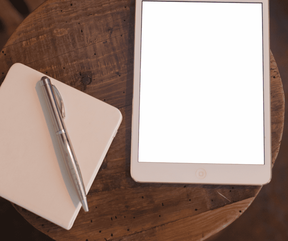 A tablet and notebook side by side on a desk, illustrating the question of what problem does this solve for each tool you own