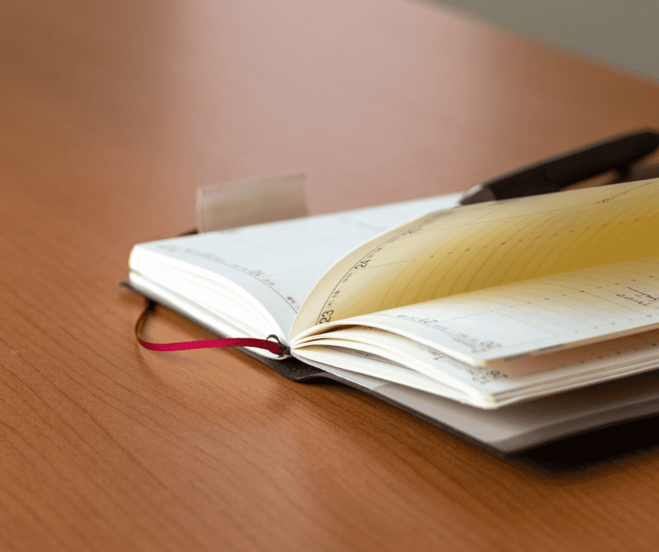 An open notebook with a dated entry beside a work in progress, illustrating experimentation vs tinkering and the endpoint that separates them